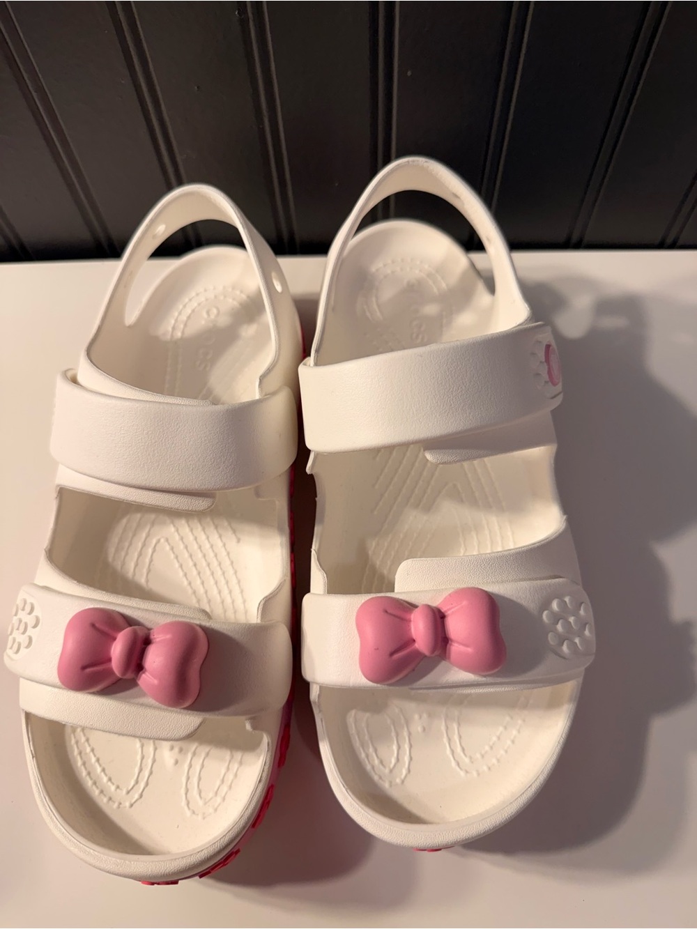 CROCS White Kids Sandals with Pink Bow Accent